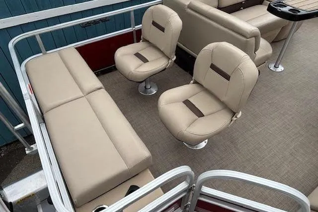 Slide: The Image of 2019 Sun Tracker SportFish 22 DLX pontoon boat interior with beige seating and carpeted floor. - 27