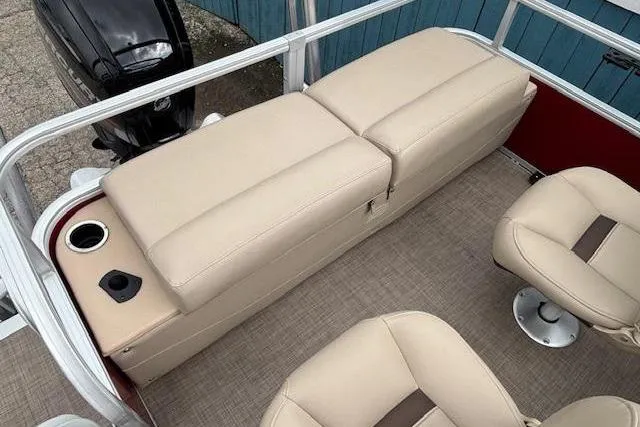 Slide: The Image of 2019 Sun Tracker SportFish 22 DLX boat interior with beige seating and cup holder. - 28