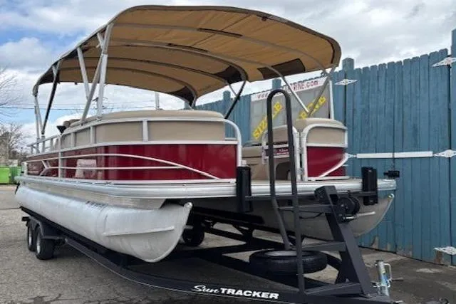 Slide: The Image of 2019 Sun Tracker SportFish 22 DLX pontoon boat on trailer, parked outdoors. - 4