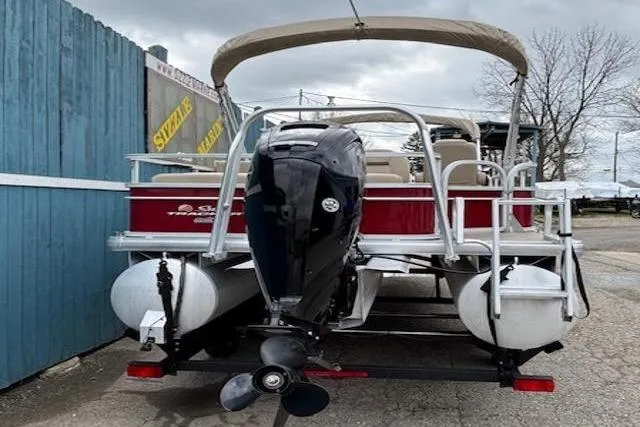 Slide: The Image of 2019 Sun Tracker SportFish 22 DLX pontoon boat with outboard motor, parked on trailer. - 7