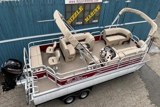 Slide: The Image of 2019 Sun Tracker SportFish 22 DLX pontoon boat with beige seating and canopy. - 9