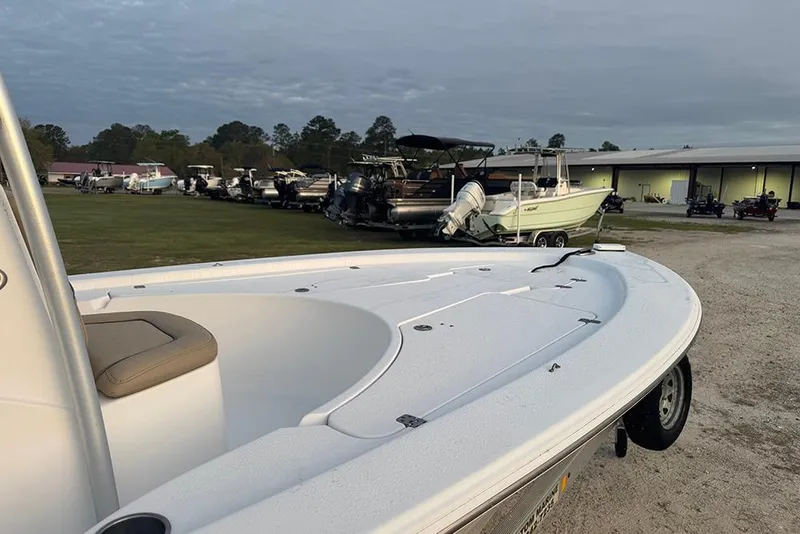 Slide: The Image of 2016 Sportsman Masters 207 Bay Boat displayed outdoors with other boats in the background. - 5