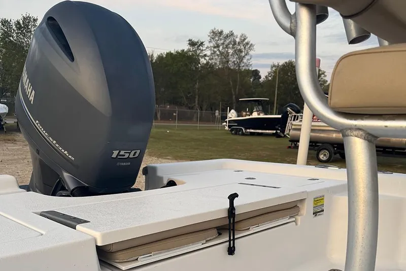 Slide: The Image of 2016 Sportsman Masters 207 Bay Boat with Yamaha 150 engine, parked outdoors. - 7