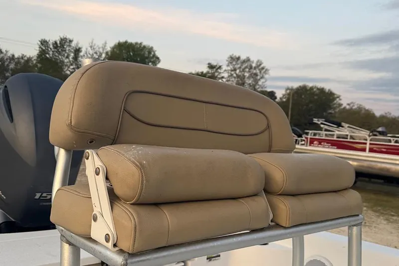 Slide: The Image of 2016 Sportsman Masters 207 Bay Boat seat with tan upholstery, outdoors. - 9