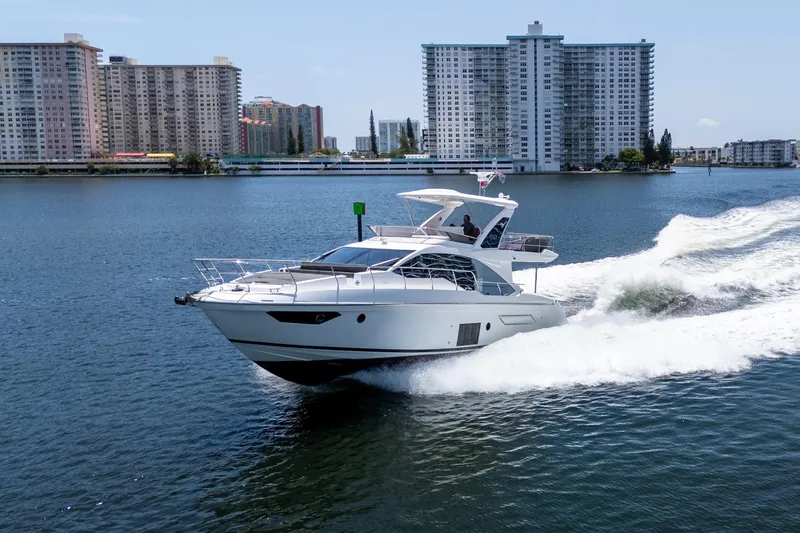 Slide: The Image of 2023 Azimut Fly 50 yacht cruising on a city waterfront. - 3