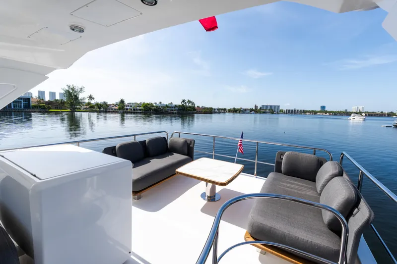Slide: The Image of Luxurious 2023 Azimut Fly 50 yacht deck with elegant seating and scenic waterfront view. - 40