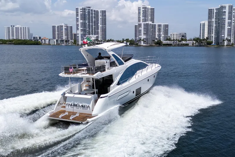 Slide: The Image of 2023 Azimut Fly 50 yacht cruising on a sunny day near city skyline. - 5