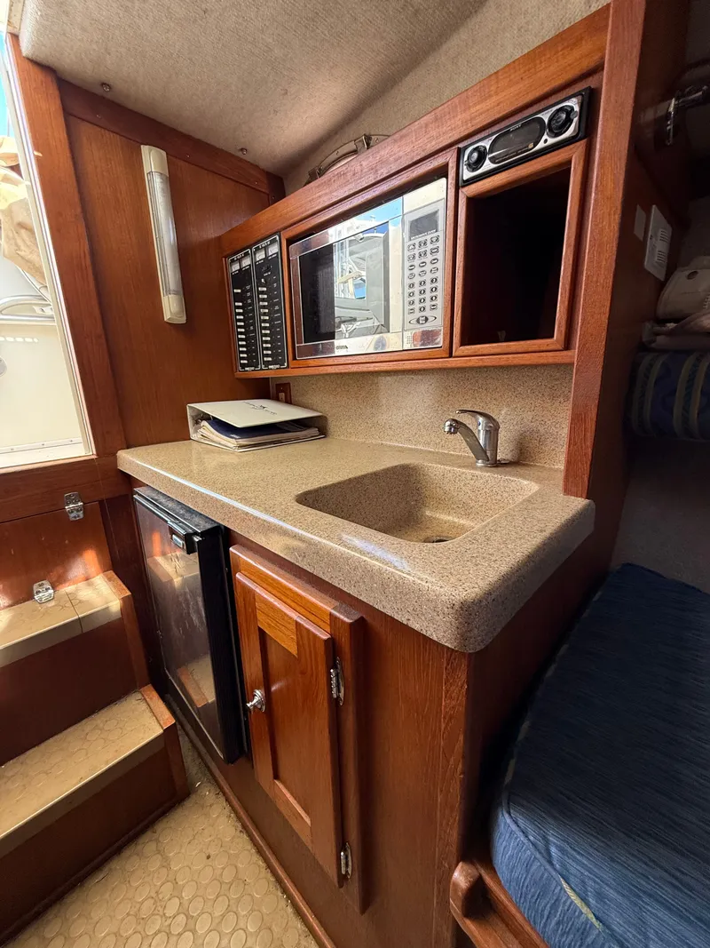 Slide: The Image of 2004 Albemarle 268 Express Fisherman galley with sink and microwave. - 40