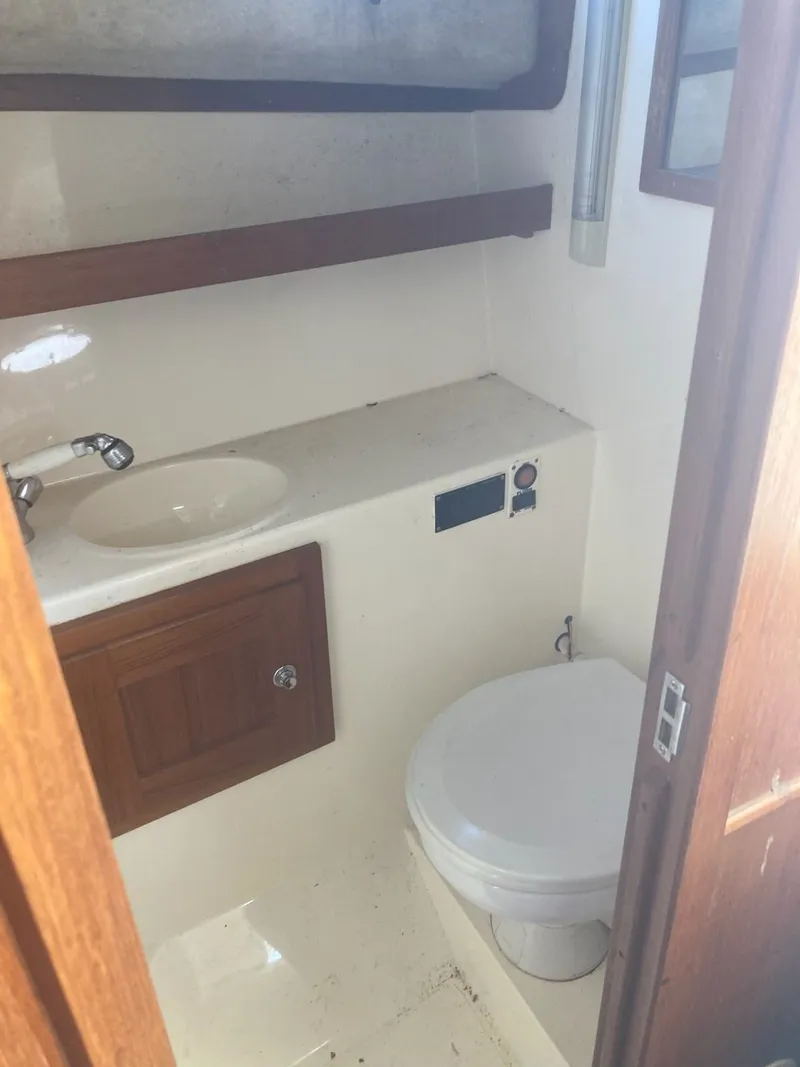 Slide: The Image of Interior of 2004 Albemarle 268 Express Fisherman with toilet and sink. - 6