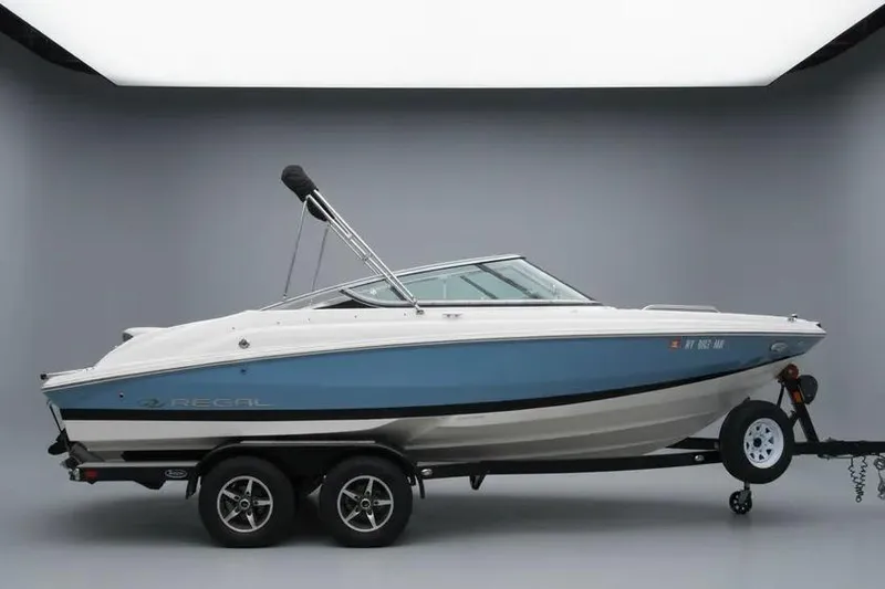 The Image of 2017 Regal 2000 ES Bowrider on trailer, blue and white design, studio setting. - 0