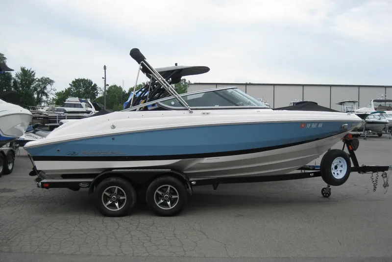Slide: The Image of 2017 Regal 2000 ES Bowrider boat on trailer, parked outdoors. - 1
