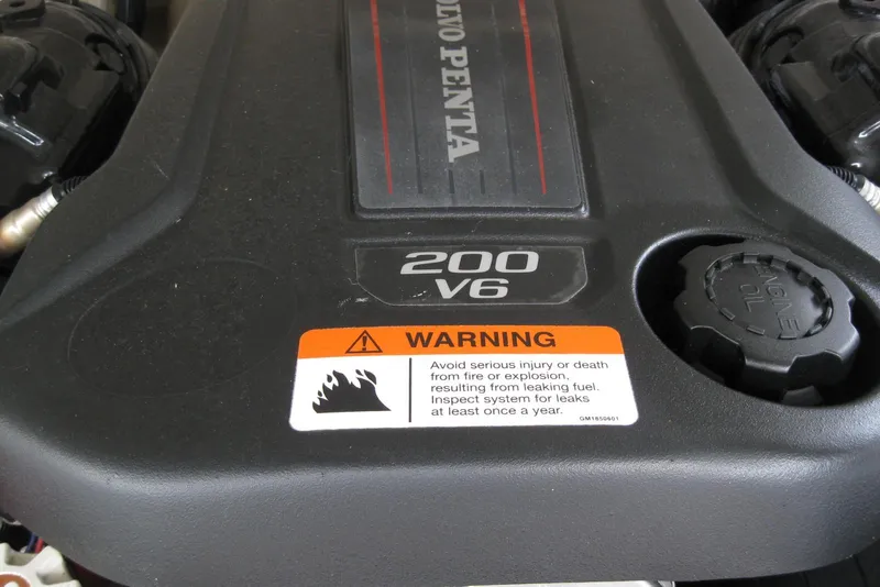 Slide: The Image of Volvo Penta 200 V6 engine cover with warning label on a 2017 Regal 2000 ES Bowrider. - 11