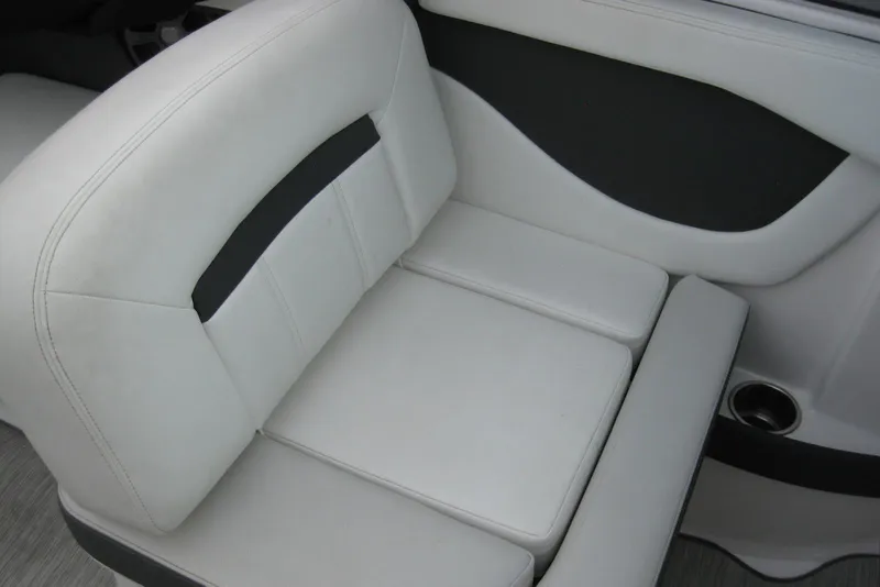 Slide: The Image of 2017 Regal 2000 ES Bowrider interior seating with white upholstery and cup holder. - 18