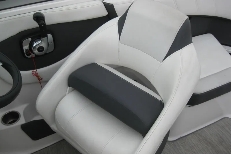 Slide: The Image of Captain's seat and controls of a 2017 Regal 2000 ES Bowrider boat. - 22