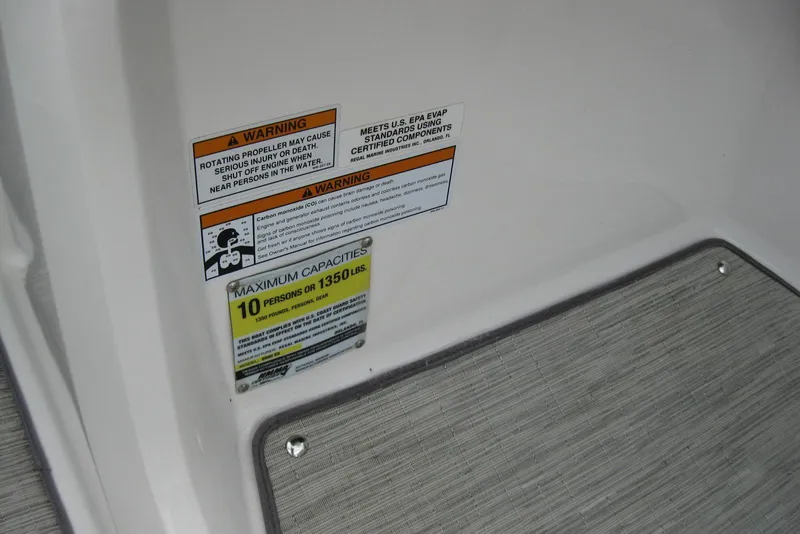 Slide: The Image of Warning labels and capacity information on a 2017 Regal 2000 ES Bowrider boat. - 25