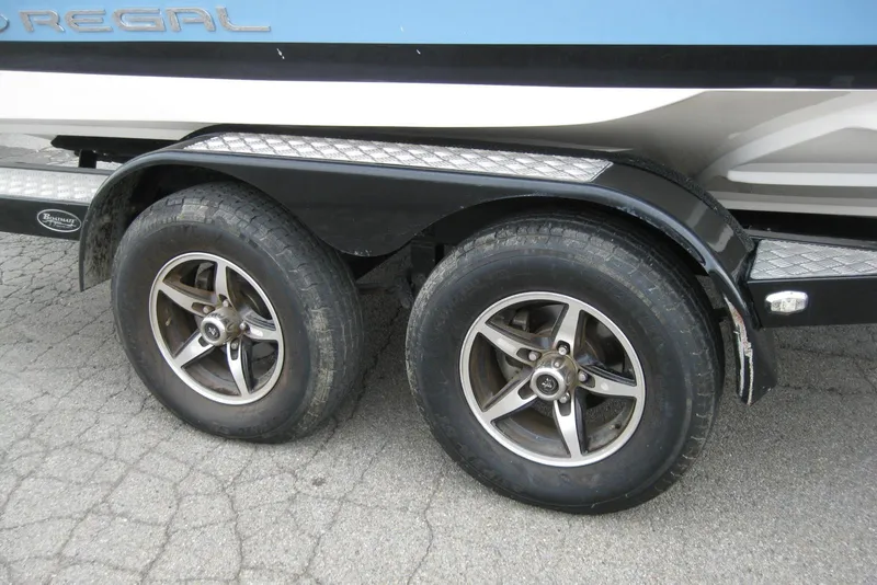 Slide: The Image of Trailer wheels of a 2017 Regal 2000 ES Bowrider boat on pavement. - 26