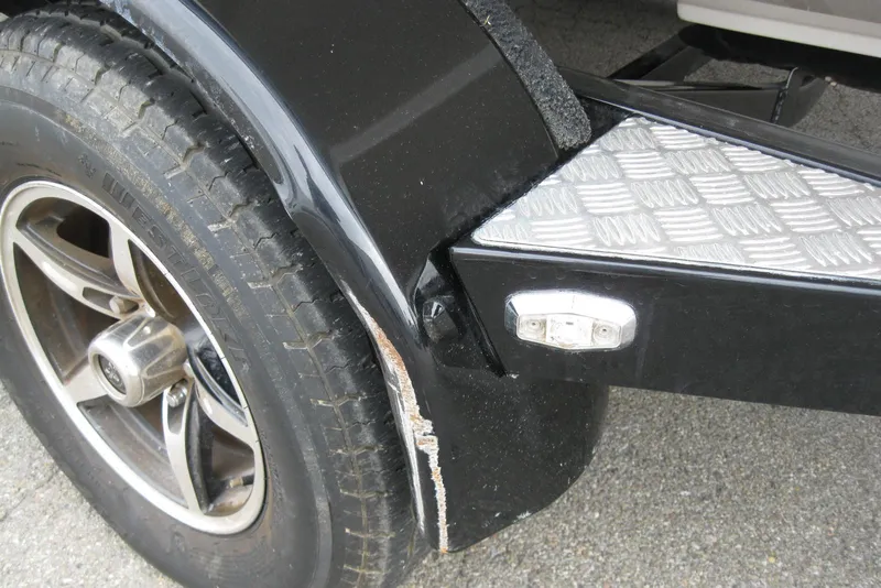 Slide: The Image of Trailer wheel and fender of 2017 Regal 2000 ES Bowrider, showing wear and scuff marks. - 27