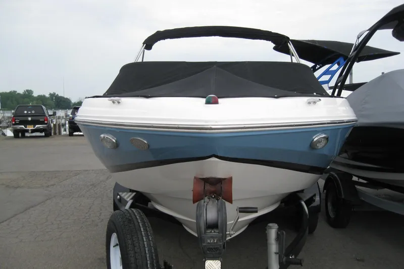 Slide: The Image of 2017 Regal 2000 ES Bowrider boat on trailer, covered and parked outdoors. - 29