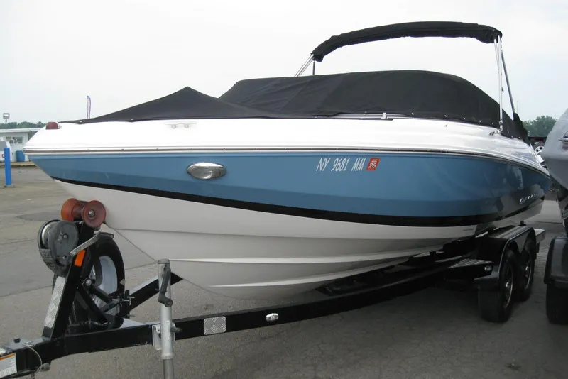 Slide: The Image of 2017 Regal 2000 ES Bowrider boat on trailer, covered and parked outdoors. - 30