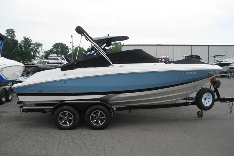 Slide: The Image of 2017 Regal 2000 ES Bowrider boat on trailer, blue and white design. - 31