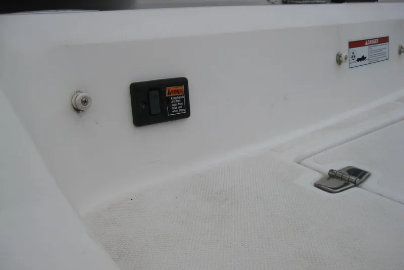 Slide: The Image of 2017 Regal 2000 ES Bowrider interior detail with warning label and latch. - 8