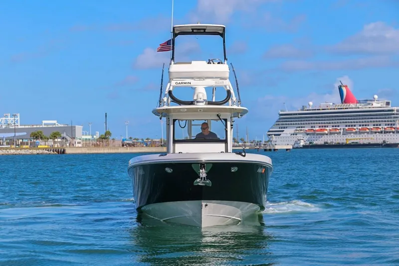 The Image of 2017 Everglades 355 Center Console boat cruising in harbor with cruise ship in background. - 0