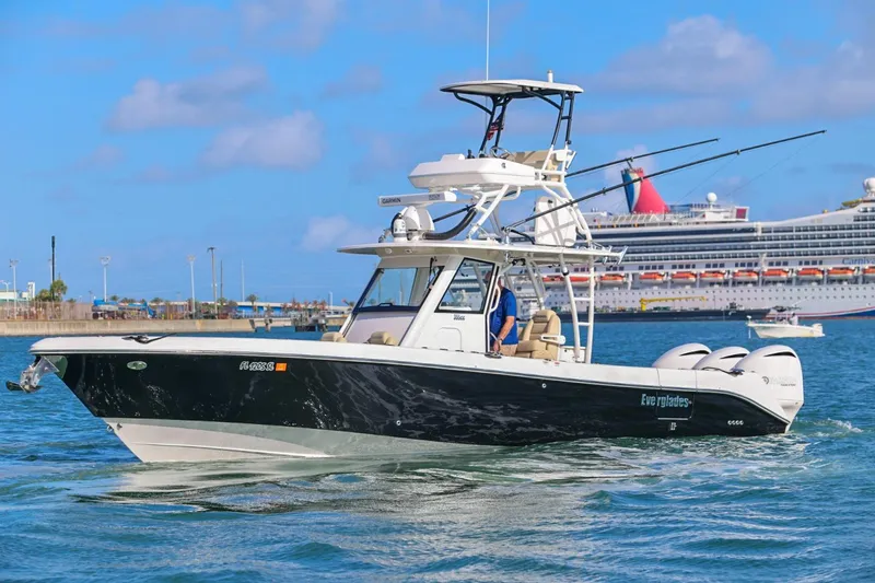 The Image of 2017 Everglades 355 Center Console boat cruising in a harbor with a cruise ship in the background. - 1