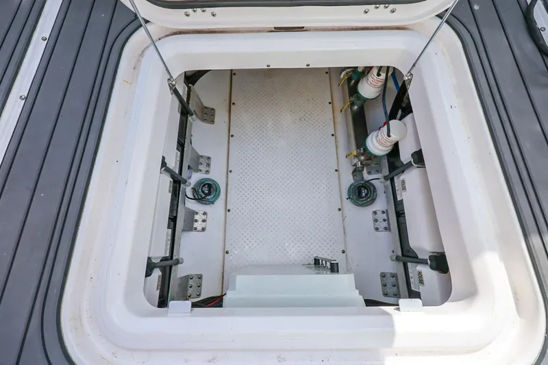 Slide: The Image of Open hatch of 2017 Everglades 355 Center Console boat, showing interior components. - 100