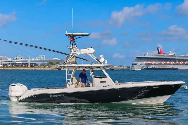 Slide: The Image of 2017 Everglades 355 Center Console boat cruising near a large cruise ship. - 11