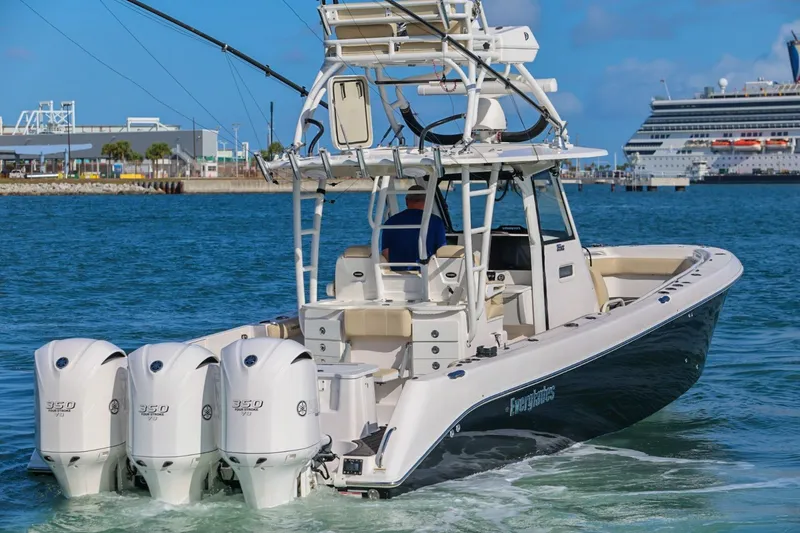 Slide: The Image of 2017 Everglades 355 Center Console boat with four engines in a harbor setting. - 15