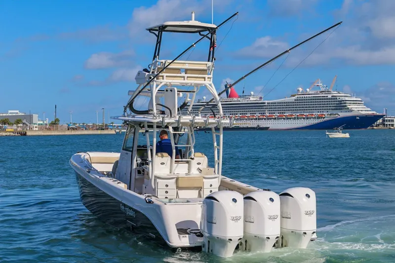 Slide: The Image of 2017 Everglades 355 Center Console boat with triple engines near a cruise ship. - 17