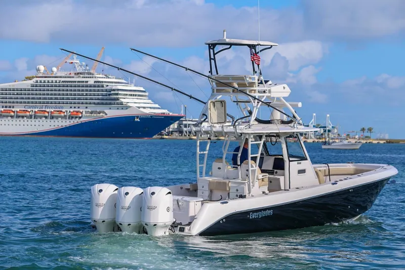 Slide: The Image of 2017 Everglades 355 Center Console boat cruising near a large cruise ship. - 18