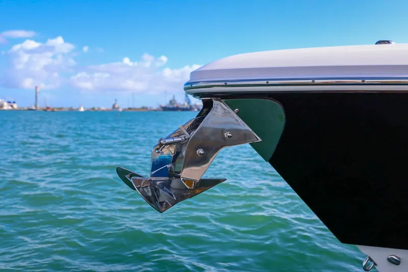 Slide: The Image of 2017 Everglades 355 Center Console boat with anchor, docked on calm blue water. - 21