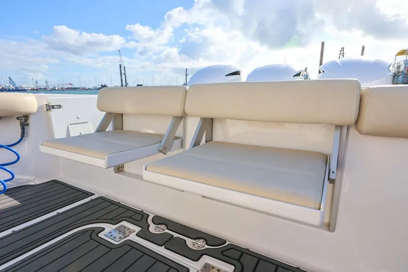 Slide: The Image of 2017 Everglades 355 Center Console boat with beige seating and sleek deck design. - 28