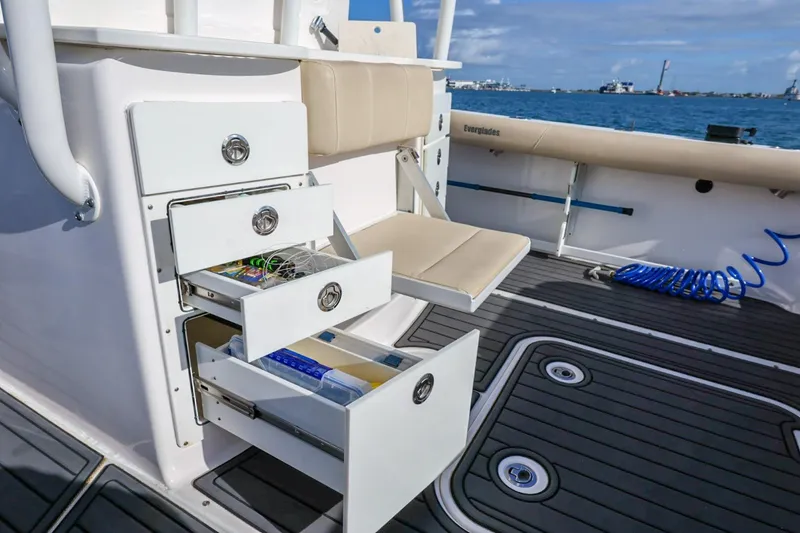 Slide: The Image of 2017 Everglades 355 Center Console boat with open storage drawers and seating on deck. - 30