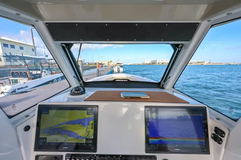 Slide: The Image of Cockpit view of 2017 Everglades 355 Center Console boat with navigation screens. - 36