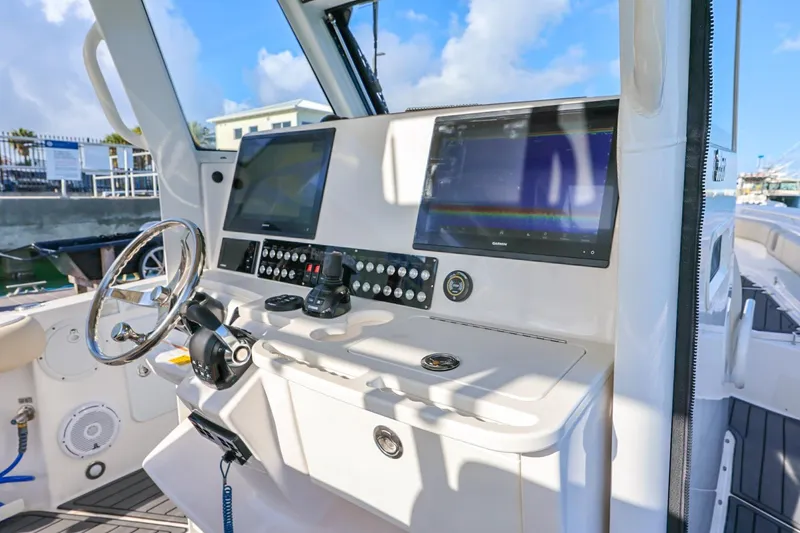 Slide: The Image of 2017 Everglades 355 Center Console boat dashboard with dual screens and steering wheel. - 37