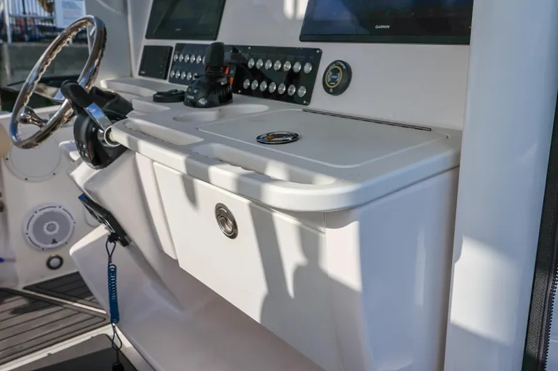 Slide: The Image of 2017 Everglades 355 Center Console boat dashboard with steering wheel and control panel. - 38