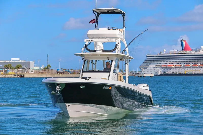 Slide: The Image of 2017 Everglades 355 Center Console boat cruising near a large cruise ship. - 4