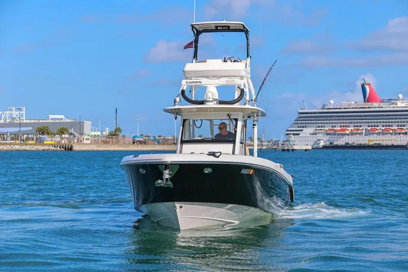 Slide: The Image of 2017 Everglades 355 Center Console boat cruising near a large cruise ship in a harbor. - 5