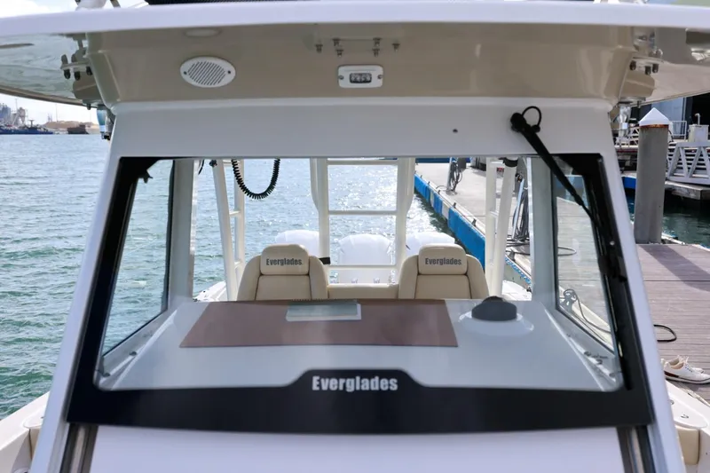Slide: The Image of 2017 Everglades 355 Center Console boat docked, showcasing helm and seating. - 50