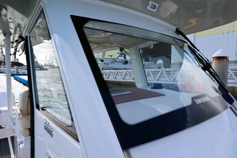 Slide: The Image of 2017 Everglades 355 Center Console boat docked at marina, showcasing sleek design. - 53