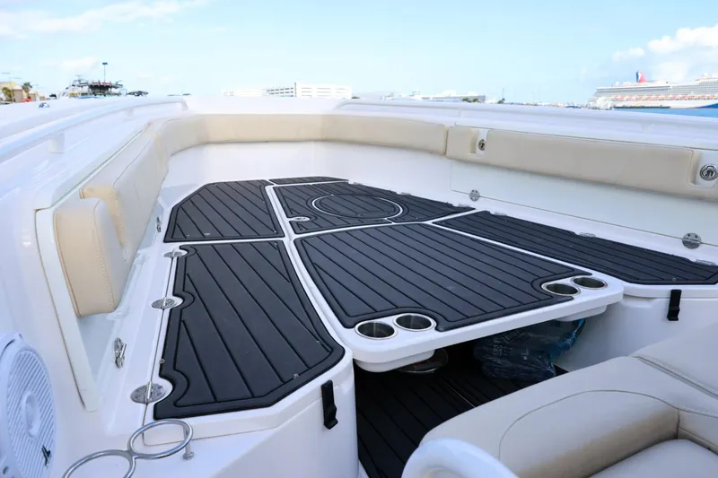 Slide: The Image of 2017 Everglades 355 Center Console boat interior with cushioned seating and sleek deck design. - 54
