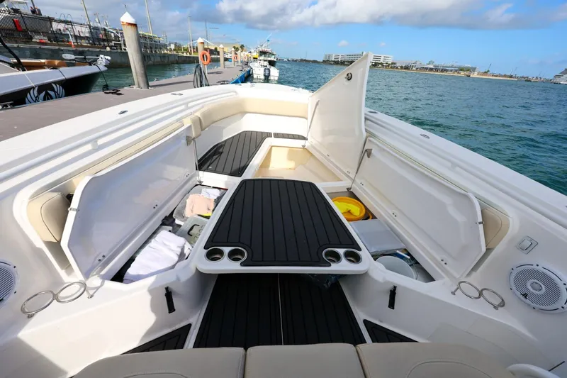 Slide: The Image of 2017 Everglades 355 Center Console boat interior with open storage compartments and seating. - 57
