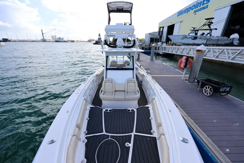 Slide: The Image of 2017 Everglades 355 Center Console boat docked at marina with clear skies. - 62