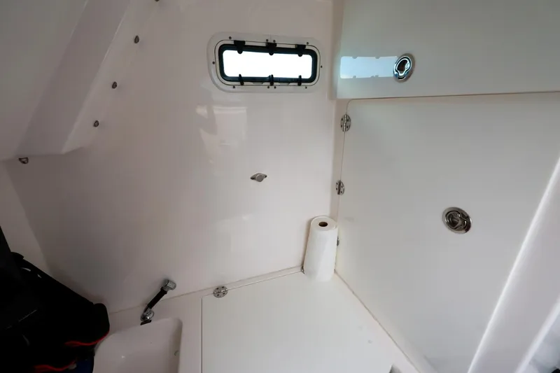 Slide: The Image of Interior of 2017 Everglades 355 Center Console boat with storage and window. - 65