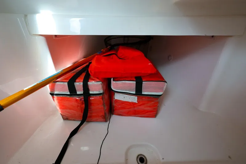 Slide: The Image of Storage compartment of 2017 Everglades 355 Center Console with safety gear and equipment. - 69