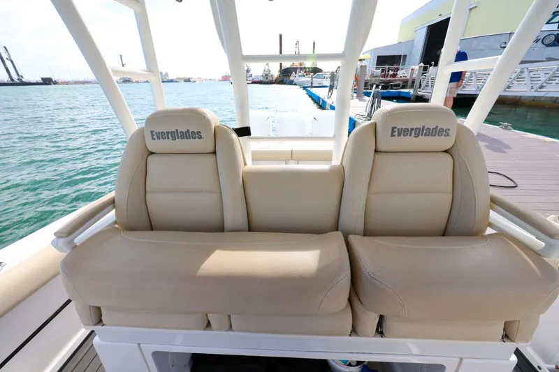 Slide: The Image of Beige seating on 2017 Everglades 355 Center Console boat at dockside. - 71