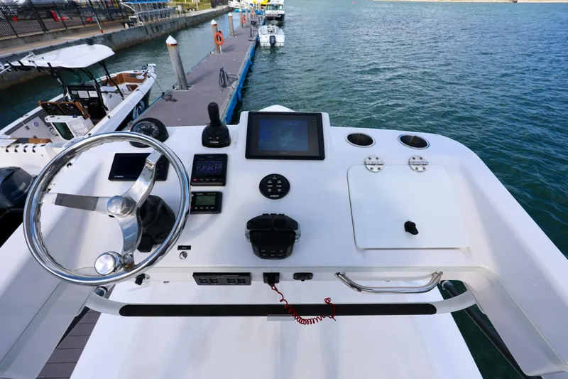 Slide: The Image of 2017 Everglades 355 Center Console helm with steering wheel and navigation controls. - 75