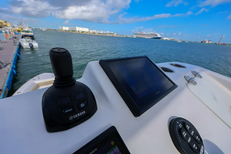 Slide: The Image of Control panel of a 2017 Everglades 355 Center Console boat with water view. - 79